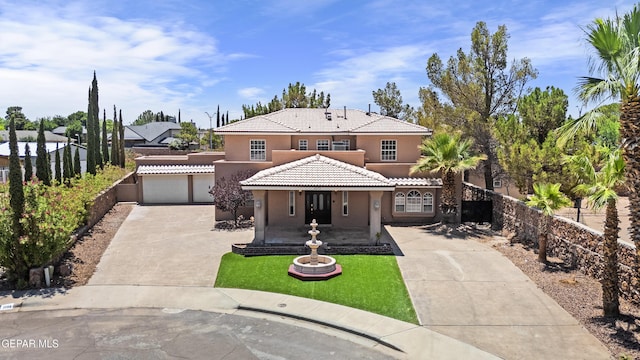 2072 Pueblo Nuevo Cir, El Paso, TX 79936 - mediterranean / spanish-style house featuring driveway, stucco siding, a tiled roof, and an attached garage