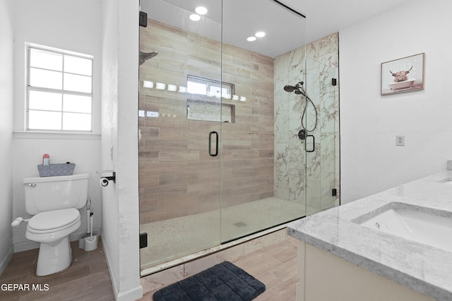 2072 Pueblo Nuevo Cir, El Paso, TX 79936 - bathroom with vanity, wood finished floors, a shower stall, and recessed lighting
