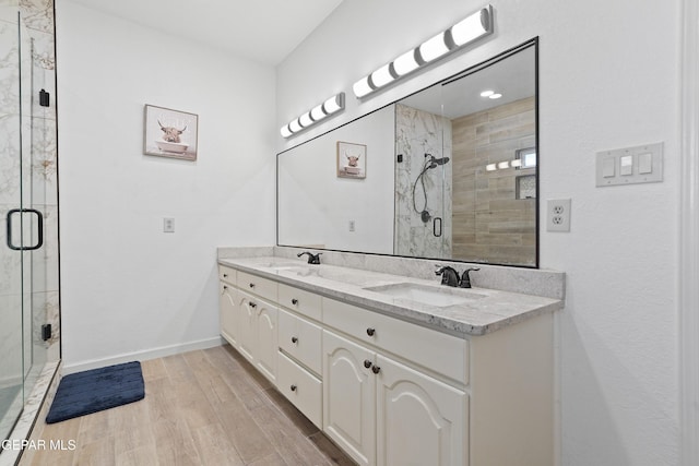 2072 Pueblo Nuevo Cir, El Paso, TX 79936 - bathroom featuring double vanity, a stall shower, and wood finished floors