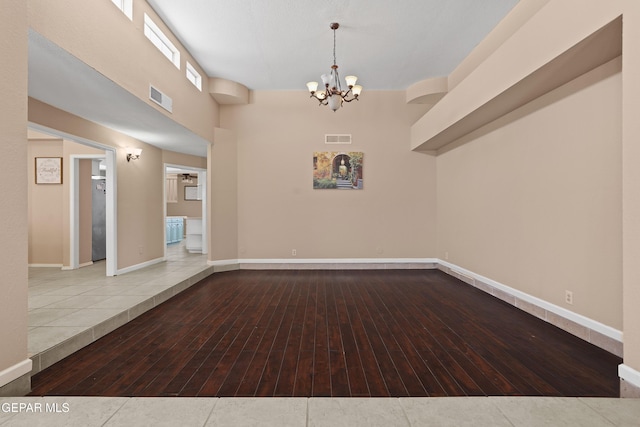 2072 Pueblo Nuevo Cir, El Paso, TX 79936 - spare room featuring hardwood / wood-style flooring and a chandelier