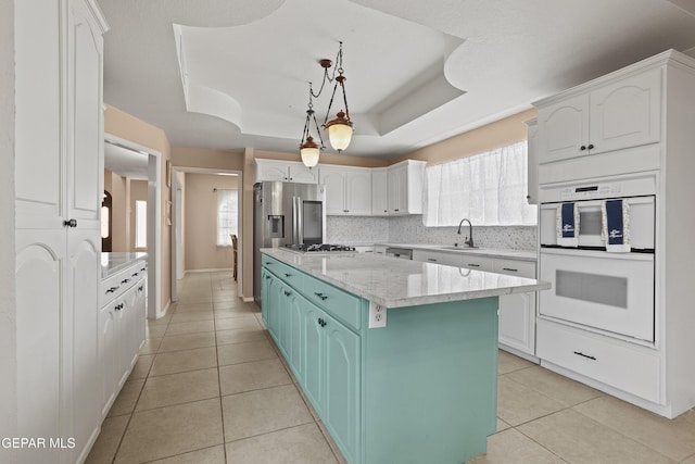 2072 Pueblo Nuevo Cir, El Paso, TX 79936 - kitchen with appliances with stainless steel finishes, a center island, and white cabinetry