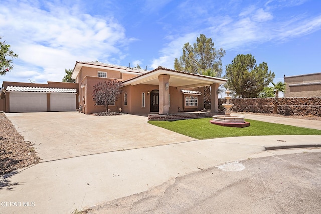 2072 Pueblo Nuevo Cir, El Paso, TX 79936 - mediterranean / spanish-style home with stucco siding, concrete driveway, a garage, a tile roof, and covered porch