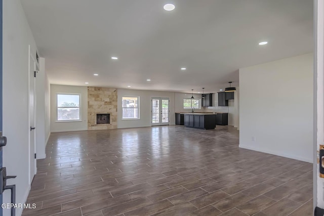 1605 Larry Wadkins Dr, El Paso, TX 79936 - unfurnished living room with plenty of natural light, recessed lighting, and dark wood-type flooring