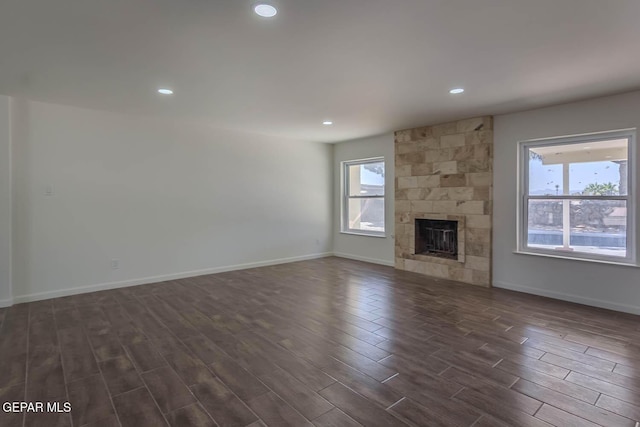 1605 Larry Wadkins Dr, El Paso, TX 79936 - unfurnished living room featuring dark wood finished floors, recessed lighting, and a fireplace