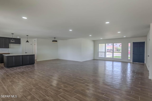 1605 Larry Wadkins Dr, El Paso, TX 79936 - unfurnished living room with recessed lighting and dark wood-type flooring