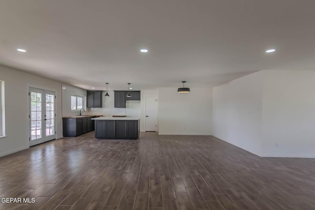 1605 Larry Wadkins Dr, El Paso, TX 79936 - unfurnished living room with recessed lighting and dark wood-type flooring