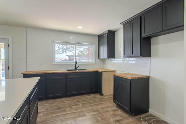 1605 Larry Wadkins Dr, El Paso, TX 79936 - kitchen featuring butcher block counters, decorative backsplash, light wood-type flooring, and recessed lighting