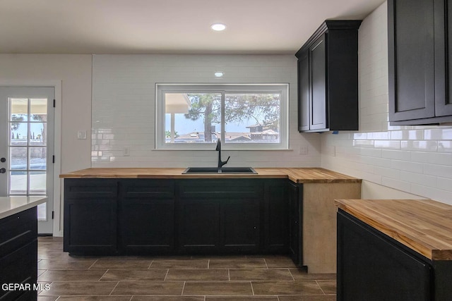 1605 Larry Wadkins Dr, El Paso, TX 79936 - kitchen with wooden counters, dark cabinets, backsplash, and recessed lighting