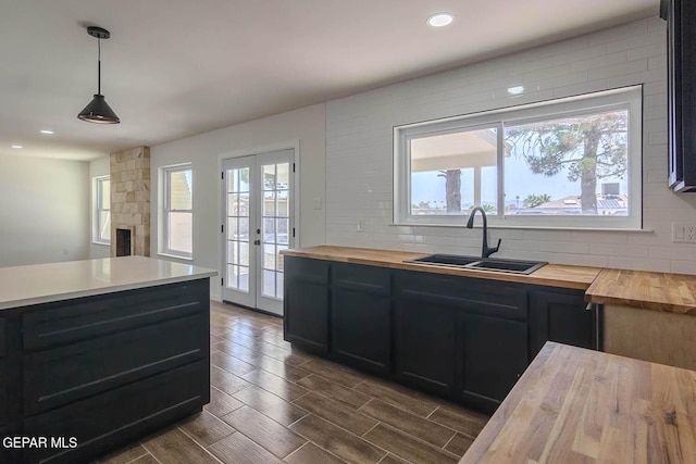 1605 Larry Wadkins Dr, El Paso, TX 79936 - kitchen featuring butcher block counters, french doors, dark wood-type flooring, recessed lighting, and backsplash