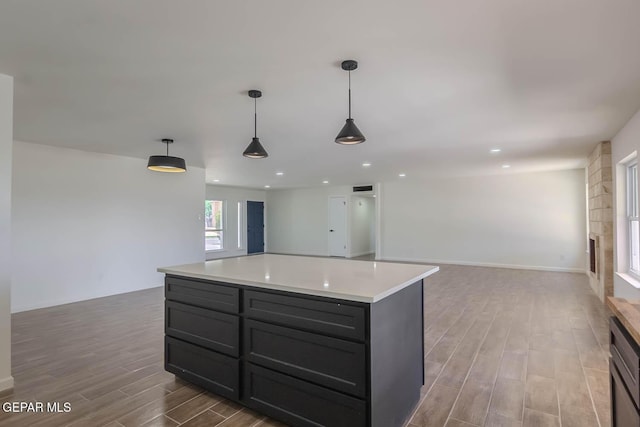 1605 Larry Wadkins Dr, El Paso, TX 79936 - kitchen featuring open floor plan, wood finished floors, light countertops, pendant lighting, and recessed lighting