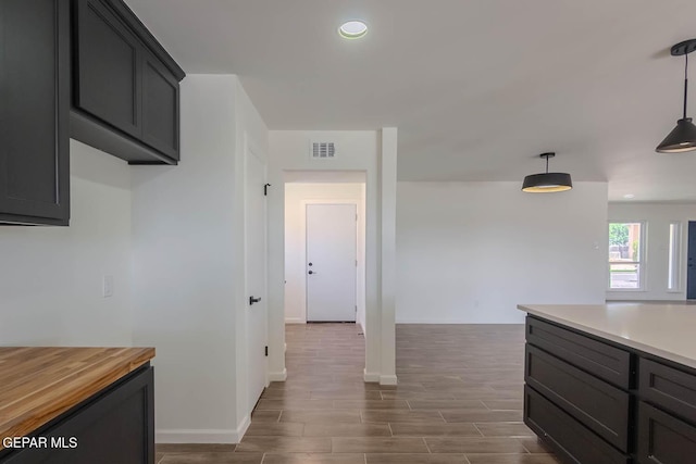 1605 Larry Wadkins Dr, El Paso, TX 79936 - kitchen featuring dark wood-style flooring, wood counters, pendant lighting, and recessed lighting