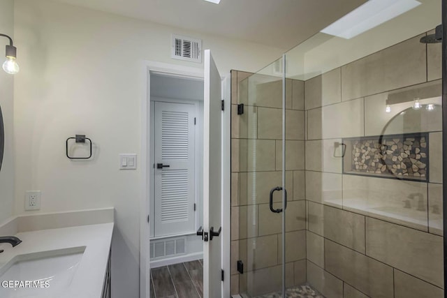 1605 Larry Wadkins Dr, El Paso, TX 79936 - full bath with vanity, a shower stall, and wood finished floors