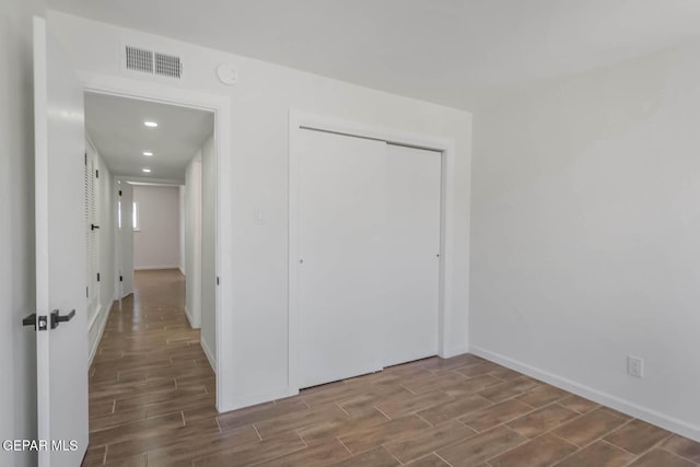 1605 Larry Wadkins Dr, El Paso, TX 79936 - unfurnished bedroom with wood tiled floors, a closet, and recessed lighting