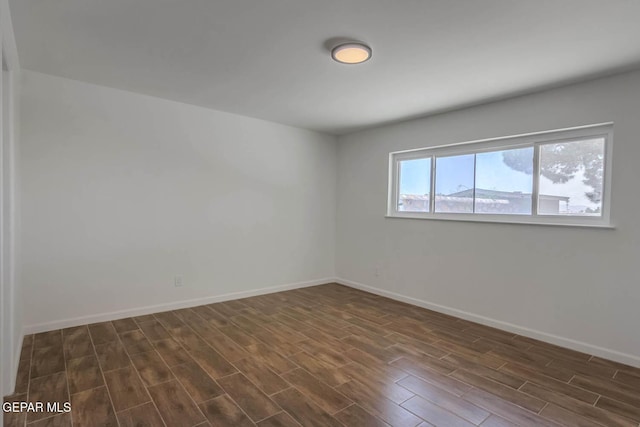 1605 Larry Wadkins Dr, El Paso, TX 79936 - empty room with dark wood-type flooring and baseboards