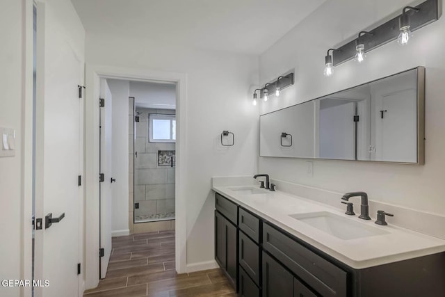 1605 Larry Wadkins Dr, El Paso, TX 79936 - bathroom featuring double vanity, a shower stall, and wood finish floors