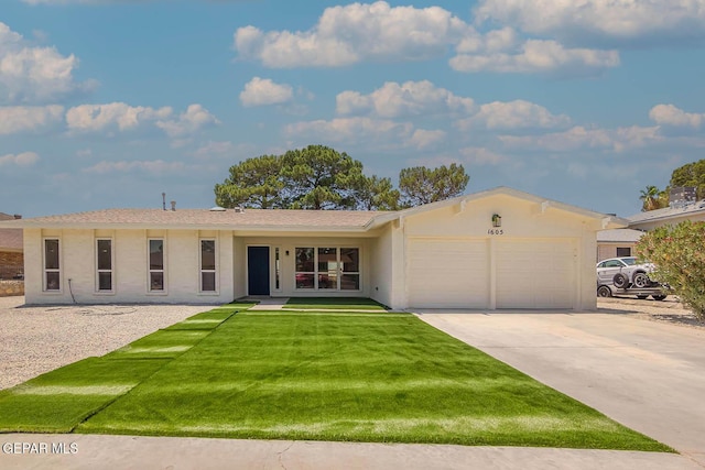 1605 Larry Wadkins Dr, El Paso, TX 79936 - ranch-style home featuring an attached garage, concrete driveway, a front yard, and stucco siding