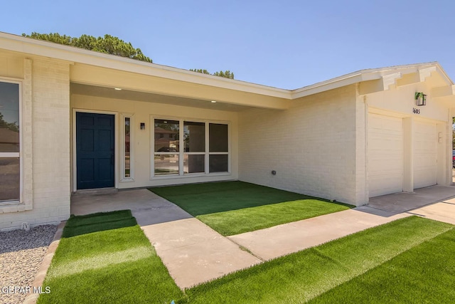 1605 Larry Wadkins Dr, El Paso, TX 79936 - view of front of house with an attached garage, brick siding, and a front yard