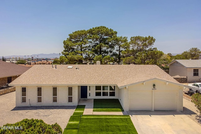 1605 Larry Wadkins Dr, El Paso, TX 79936 - ranch-style house featuring a garage, concrete driveway, a shingled roof, and a front yard