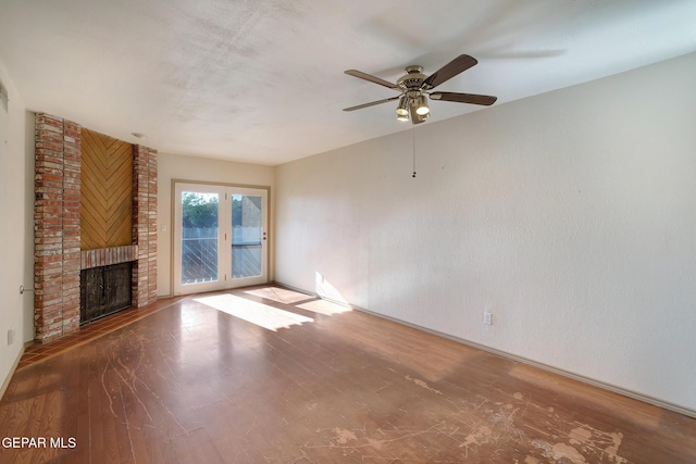 417 Irondale Dr Unit M, El Paso, TX 79912 - unfurnished living room with a ceiling fan, wood finished floors, and a fireplace