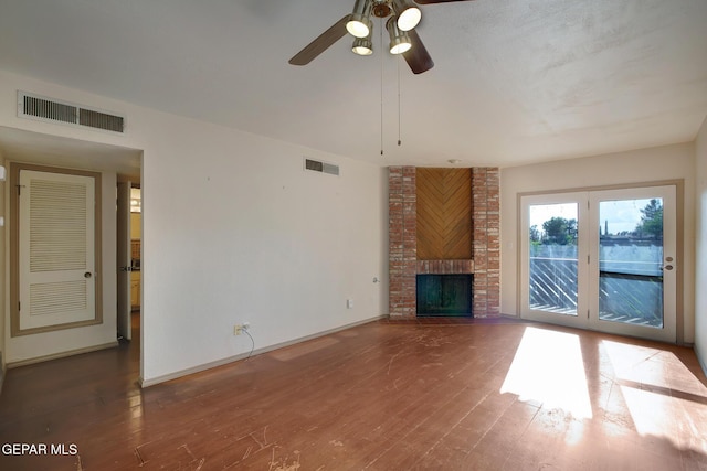 417 Irondale Dr Unit M, El Paso, TX 79912 - unfurnished living room with ceiling fan, wood finished floors, and a fireplace