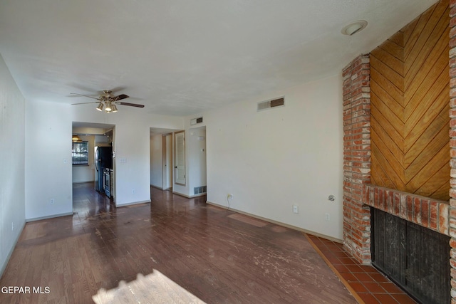 417 Irondale Dr Unit M, El Paso, TX 79912 - unfurnished living room with wood finished floors, ceiling fan, and a brick fireplace