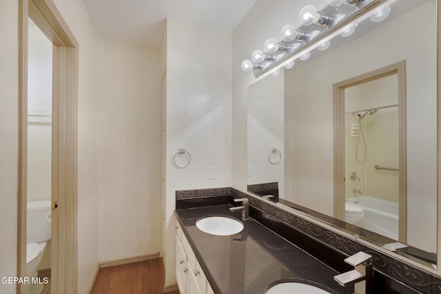 417 Irondale Dr Unit M, El Paso, TX 79912 - full bath with double vanity, wood finished floors, and shower / washtub combination