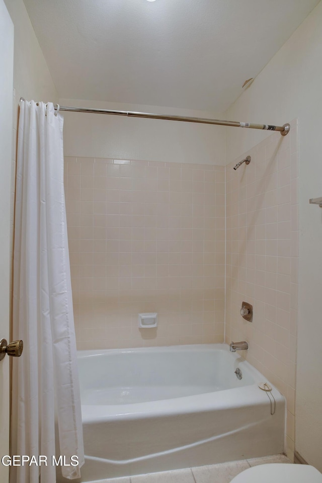 417 Irondale Dr Unit M, El Paso, TX 79912 - bathroom featuring shower / bath combination with curtain and tile patterned floors