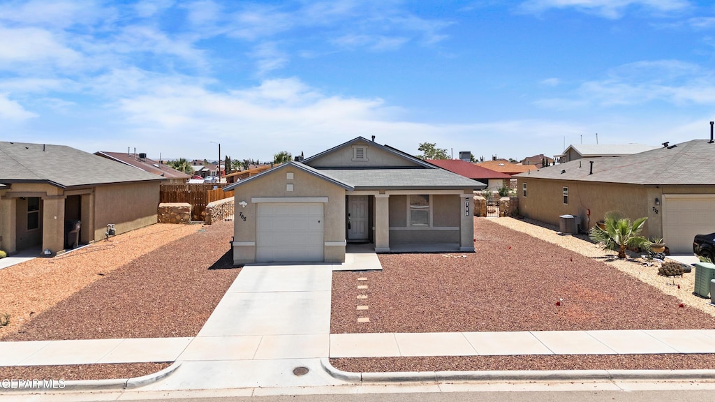 768 Villa Romero Dr, El Paso, TX 79928 - ranch-style home with concrete driveway, an attached garage, a residential view, and stucco siding