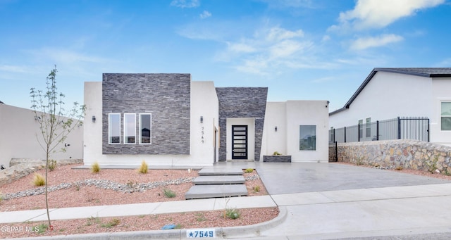 7549 Enchanted Park Dr 706849, El Paso, TX 79911 - contemporary home with driveway, stone siding, and stucco siding