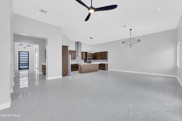 7549 Enchanted Park Dr 706849, El Paso, TX 79911 - unfurnished living room featuring a chandelier, a ceiling fan, light marble finish flooring, recessed lighting, and a towering ceiling
