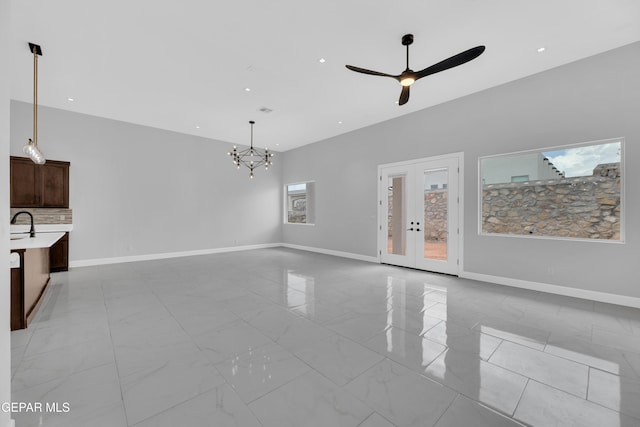 7549 Enchanted Park Dr 706849, El Paso, TX 79911 - unfurnished living room featuring a chandelier, french doors, ceiling fan, recessed lighting, and light marble finish flooring