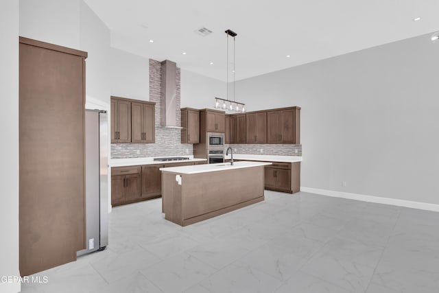 7549 Enchanted Park Dr 706849, El Paso, TX 79911 - kitchen featuring wall chimney exhaust hood, appliances with stainless steel finishes, a towering ceiling, light marble finish floors, and light countertops