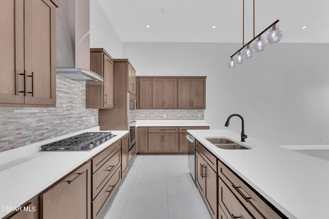 7549 Enchanted Park Dr 706849, El Paso, TX 79911 - kitchen featuring stainless steel appliances, wall chimney exhaust hood, light marble finish floors, decorative light fixtures, and light countertops