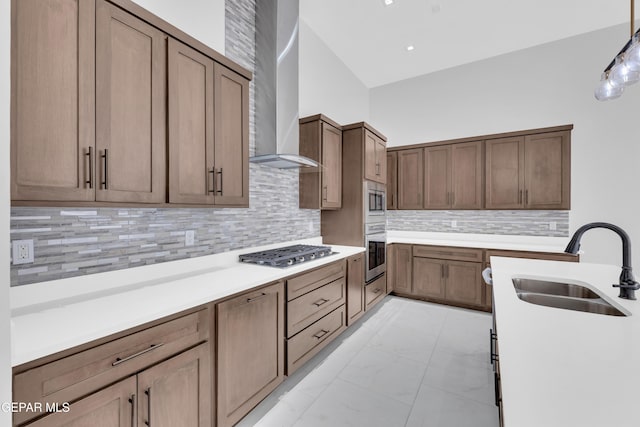 7549 Enchanted Park Dr 706849, El Paso, TX 79911 - kitchen with appliances with stainless steel finishes, wall chimney exhaust hood, light marble finish floors, decorative backsplash, and light countertops