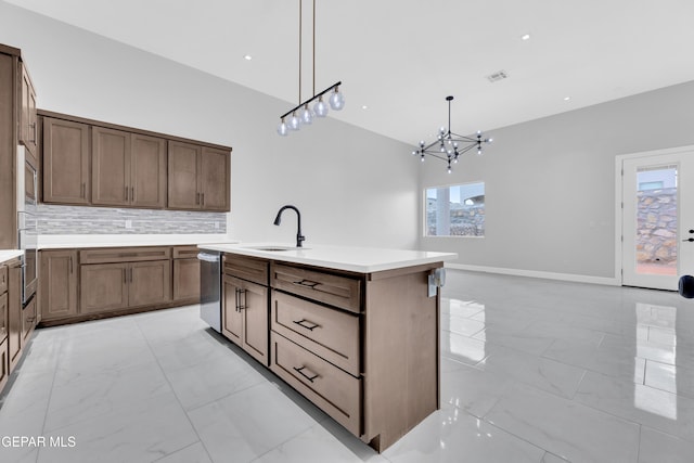 7549 Enchanted Park Dr 706849, El Paso, TX 79911 - kitchen with stainless steel appliances, light marble finish flooring, a chandelier, and backsplash