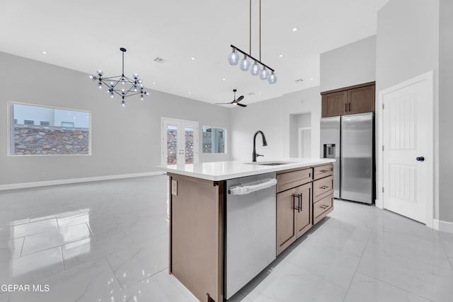 7549 Enchanted Park Dr 706849, El Paso, TX 79911 - kitchen featuring dishwasher, stainless steel refrigerator with ice dispenser, open floor plan, light marble finish flooring, and a chandelier