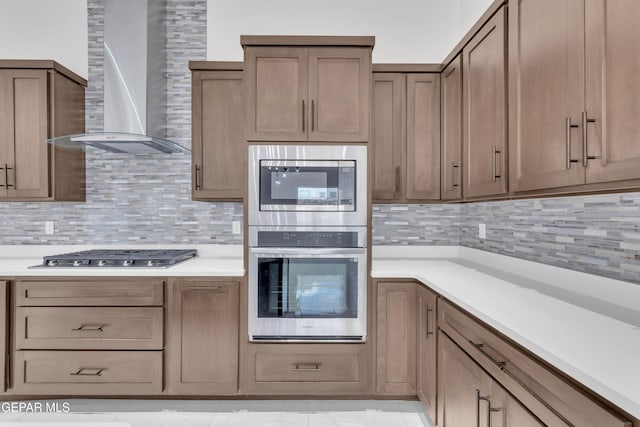 7549 Enchanted Park Dr 706849, El Paso, TX 79911 - kitchen with stainless steel appliances, wall chimney range hood, backsplash, and light countertops