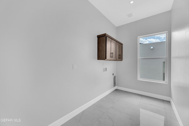 7549 Enchanted Park Dr 706849, El Paso, TX 79911 - laundry area featuring electric dryer hookup, cabinet space, light marble finish floors, and hookup for a washing machine