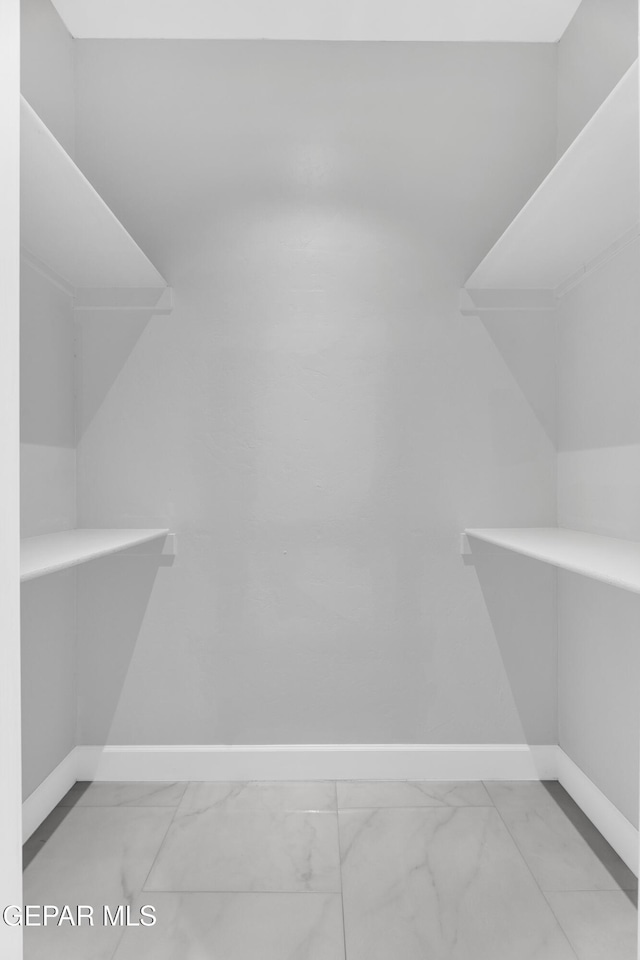 7549 Enchanted Park Dr 706849, El Paso, TX 79911 - walk in closet featuring marble finish flooring