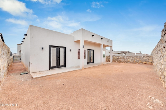 7549 Enchanted Park Dr 706849, El Paso, TX 79911 - back of house with french doors, stucco siding, a fenced backyard, and a patio