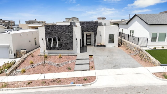 7549 Enchanted Park Dr 706849, El Paso, TX 79911 - contemporary house featuring stucco siding, driveway, and a residential view