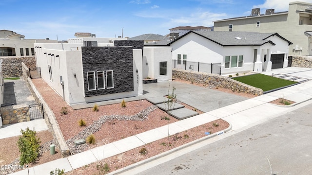 7549 Enchanted Park Dr 706849, El Paso, TX 79911 - view of front of house with stucco siding, a gate, driveway, and stone siding