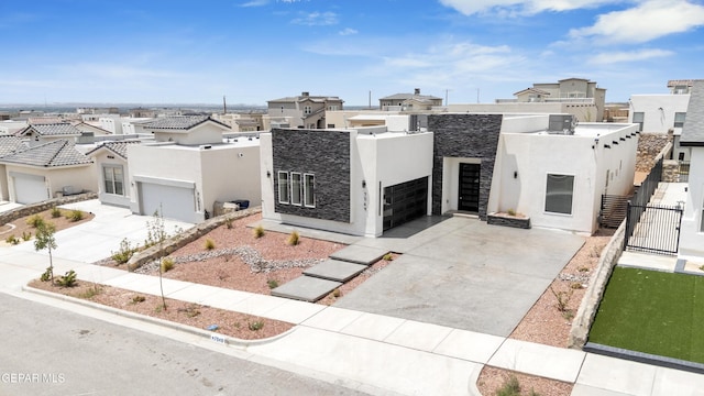 7549 Enchanted Park Dr 706849, El Paso, TX 79911 - view of front facade featuring stucco siding, a gate, concrete driveway, a residential view, and a garage