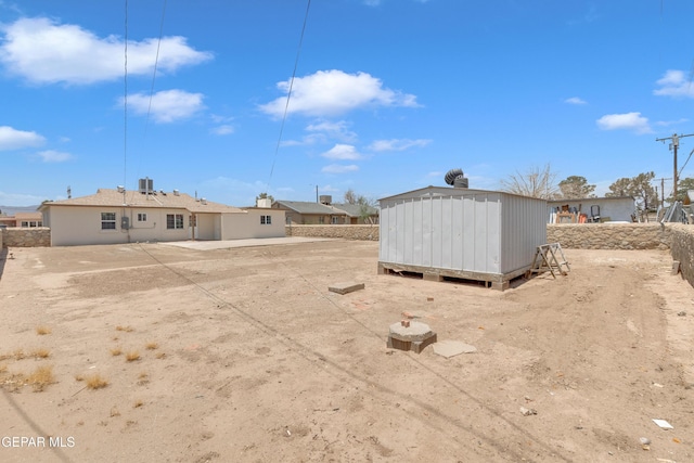 224 Ben Swain Dr, El Paso, TX 79915 - rear view of house with a storage unit