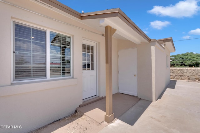 224 Ben Swain Dr, El Paso, TX 79915 - view of exterior entry with stucco siding and a patio