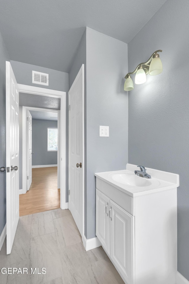 224 Ben Swain Dr, El Paso, TX 79915 - bathroom featuring marble look tiles and vanity