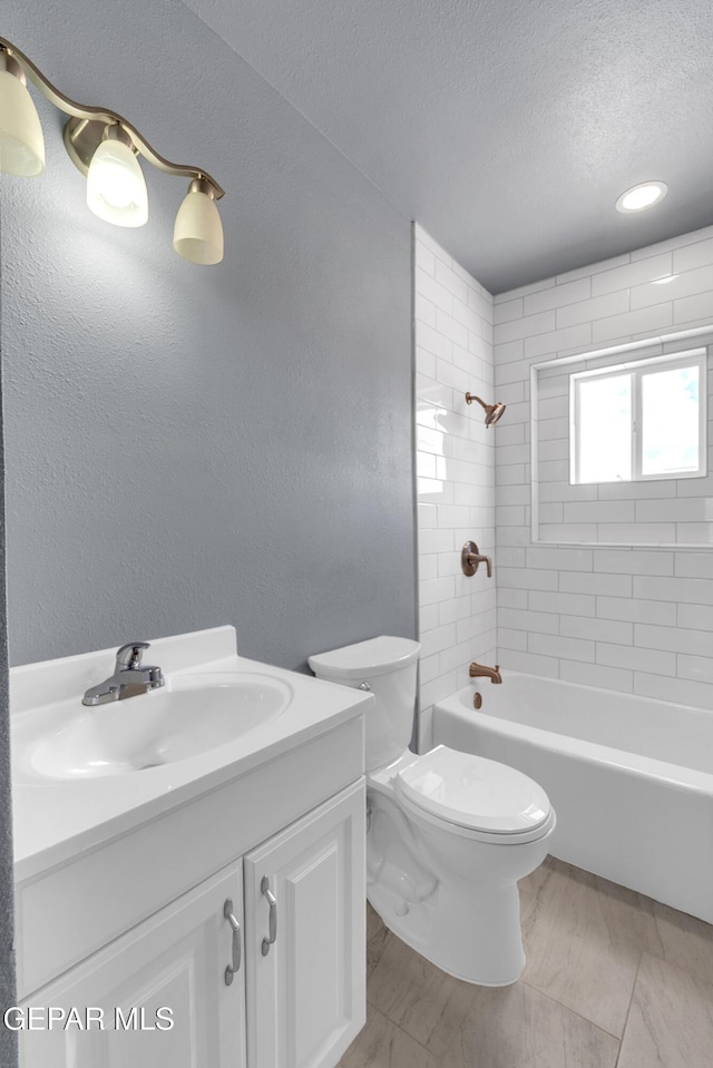 224 Ben Swain Dr, El Paso, TX 79915 - full bath with vanity, a textured ceiling, shower / washtub combination, and a textured wall