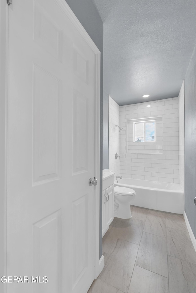 224 Ben Swain Dr, El Paso, TX 79915 - bathroom featuring a textured ceiling, vanity, marble finish flooring, and shower / bathtub combination