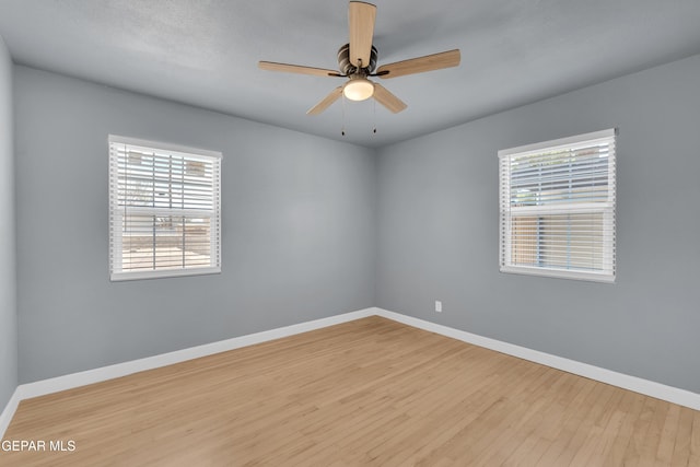 224 Ben Swain Dr, El Paso, TX 79915 - unfurnished room with healthy amount of natural light, wood finished floors, and a ceiling fan