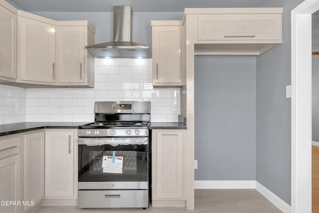224 Ben Swain Dr, El Paso, TX 79915 - kitchen with stainless steel gas range oven, wall chimney exhaust hood, dark countertops, and tasteful backsplash